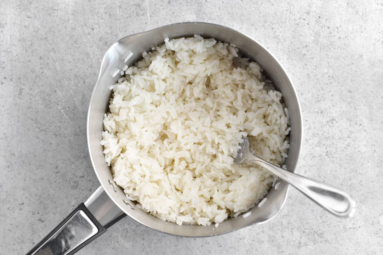 fluff coconut rice with a fork