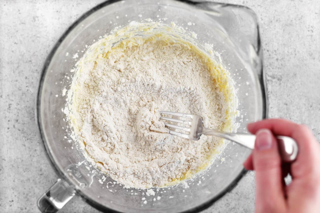 fork mixing dry ingredients in batter bowl