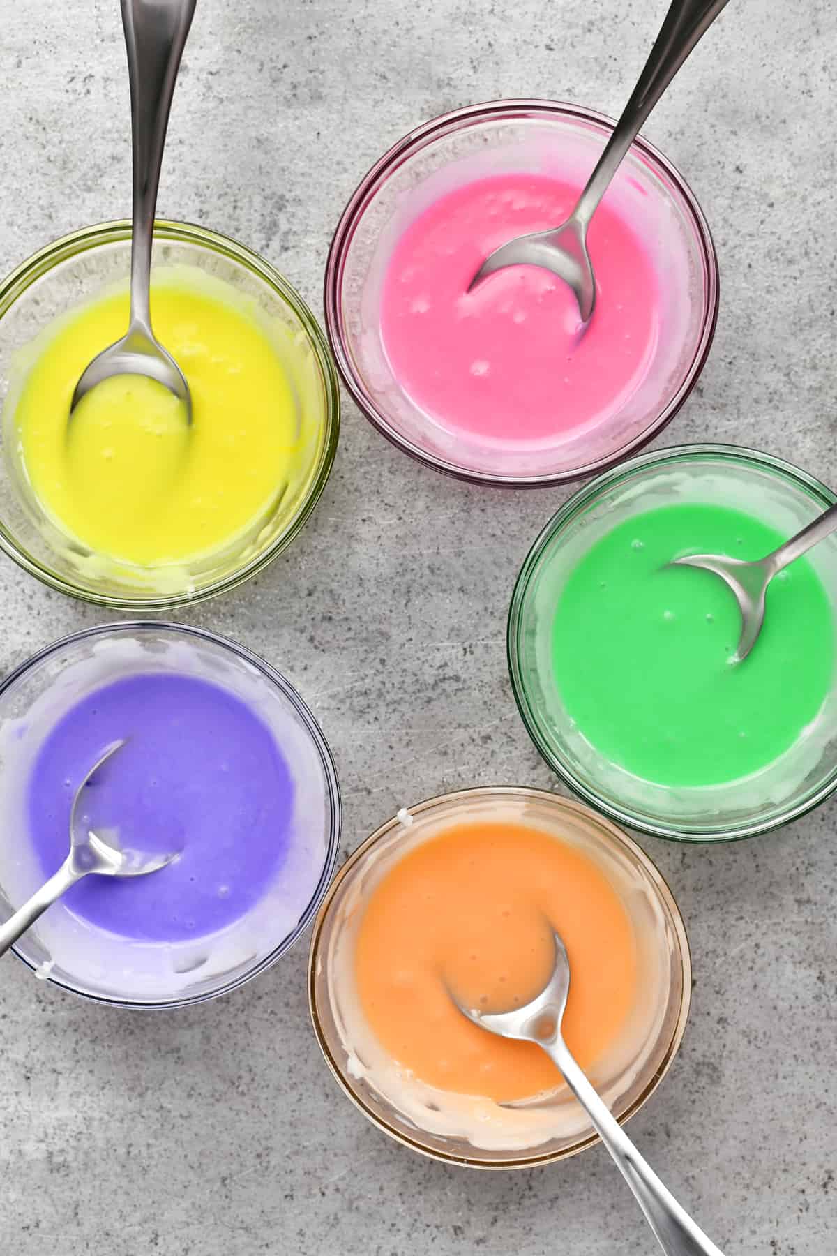 five colorful bowls of glace icing