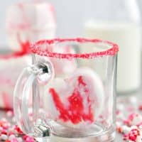 a heart shaped hot chocolate bomb in a glass cup