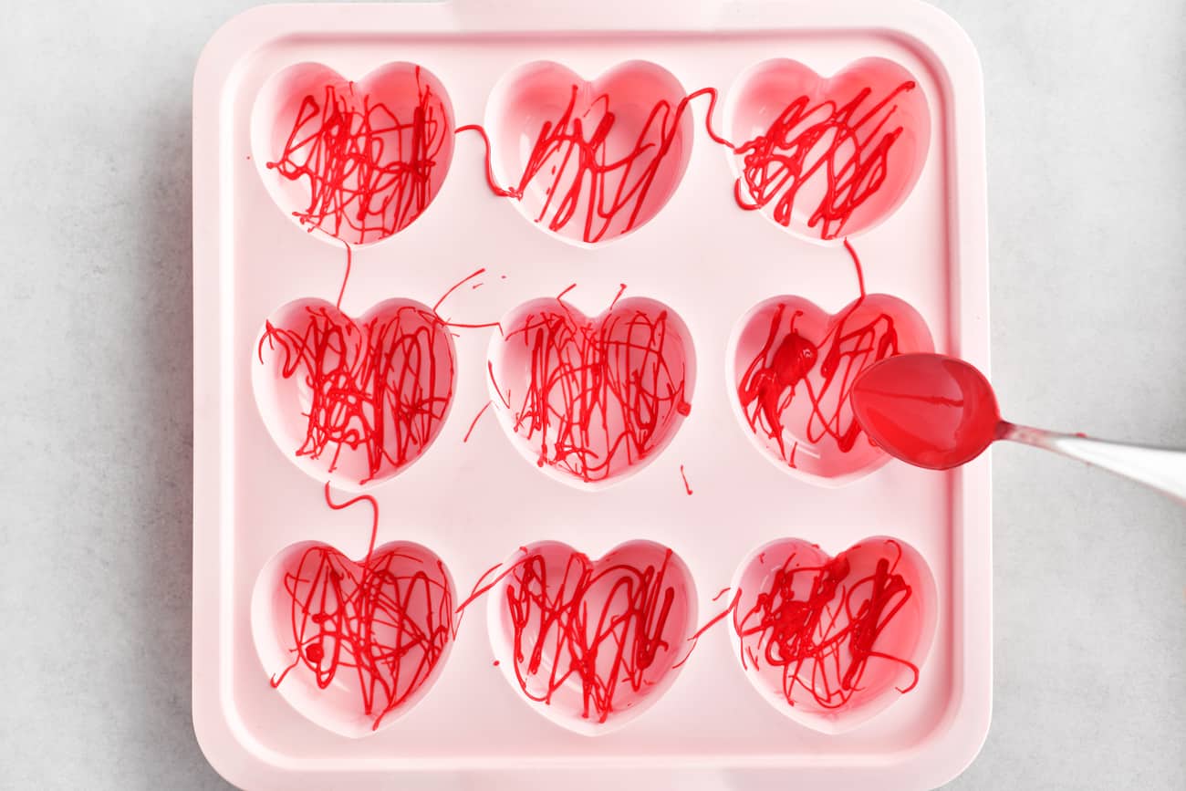 Drizzle red candy melts in silicone mold.