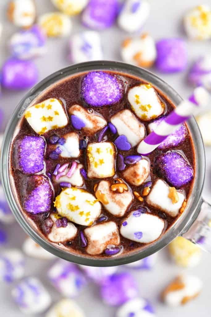 mug of hot chocolate with purple sprinkles on marshmallows