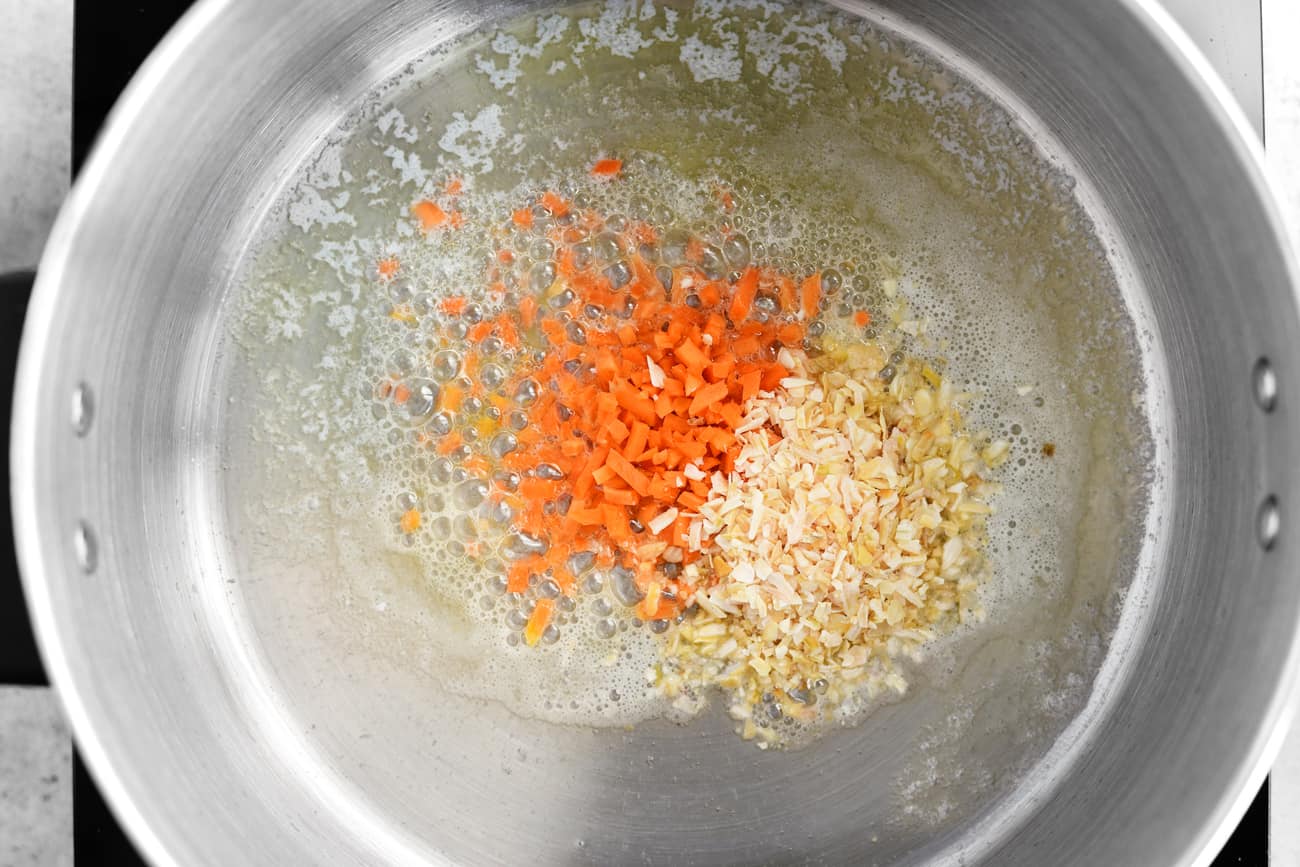 carrots, onion flakes, and grease in a pot