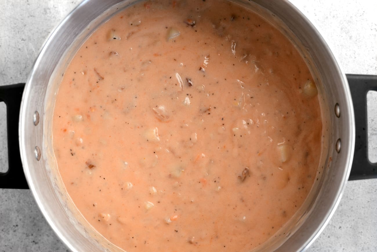 potato bacon and bean soup in a cooking pot