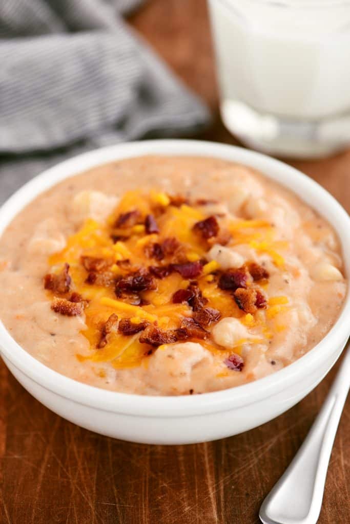 a bowl with potato bacon and bean soup in it