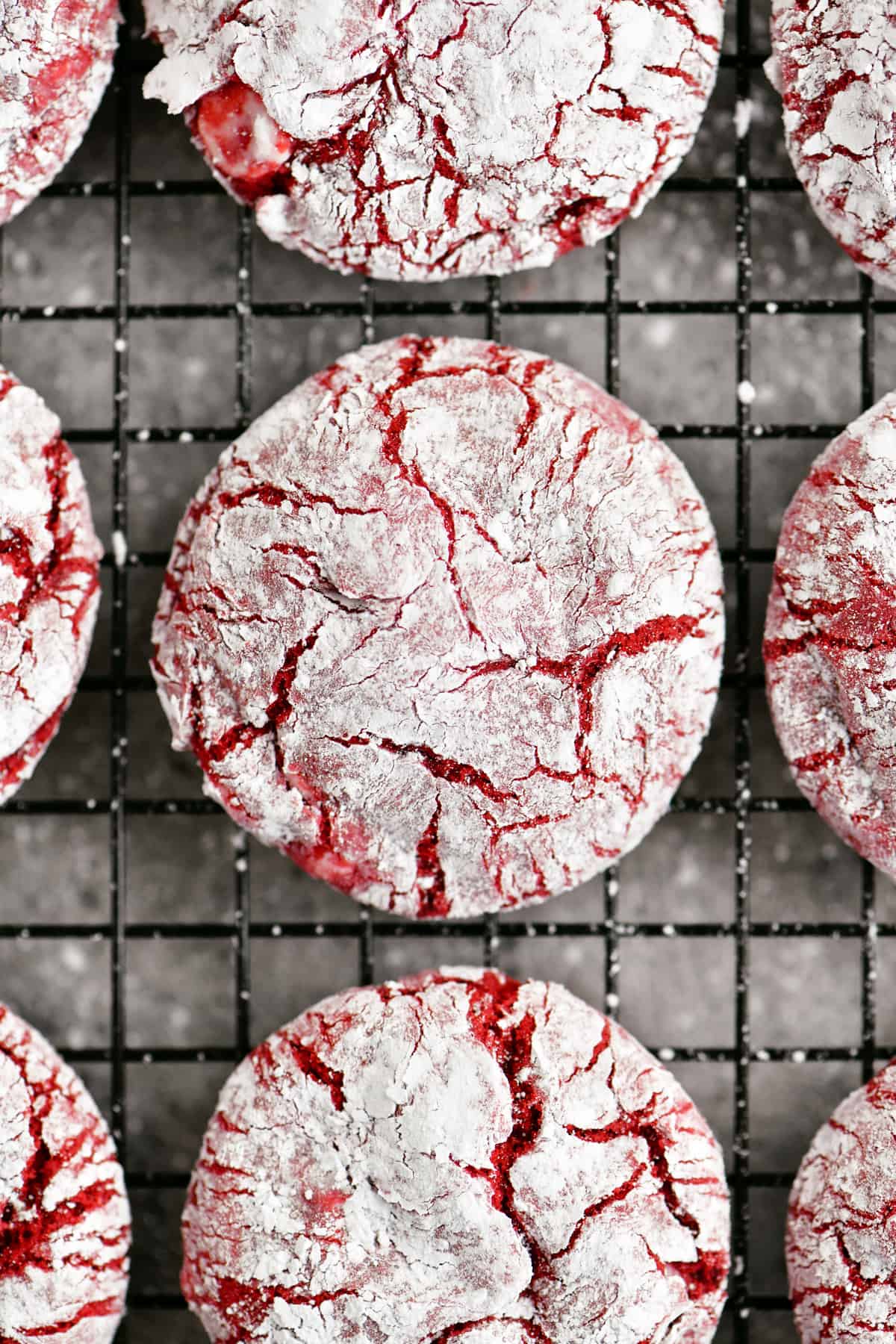 crackle red velvet cookies on a black wire rack