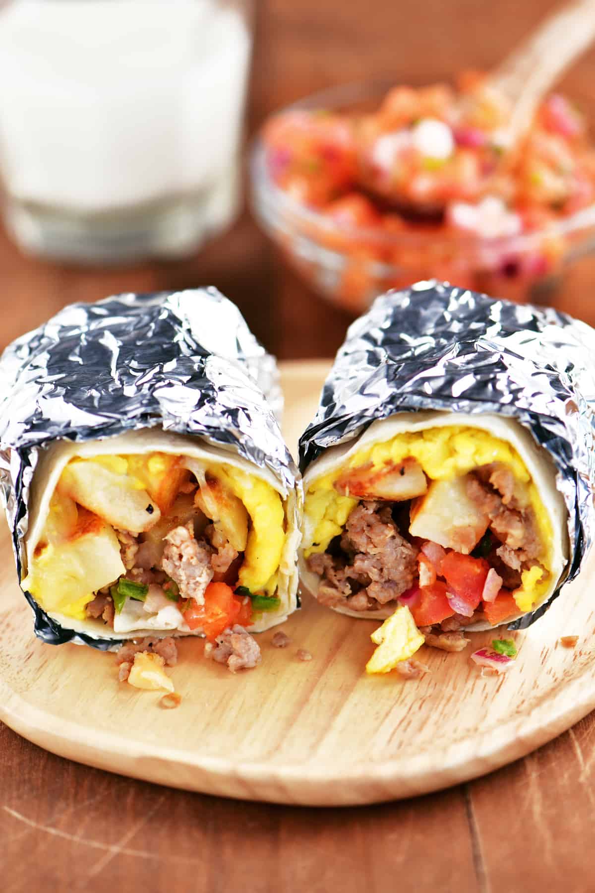 foil wrapped southwest breakfast burritos on a plate