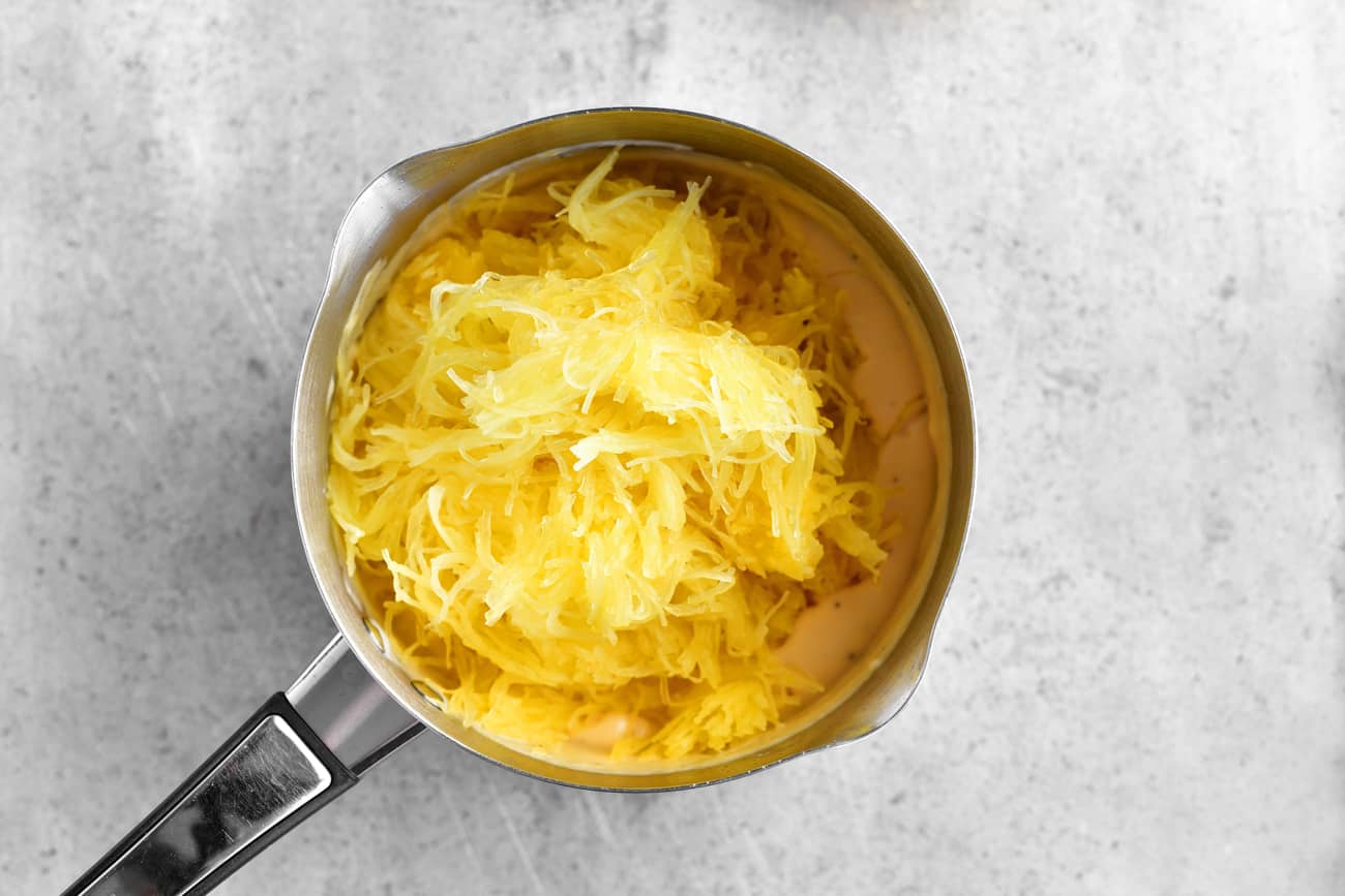 mixing the cheese and squash
