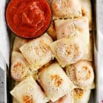 silver tray of two ingredient dough pizza rolls with sauce in a bowl