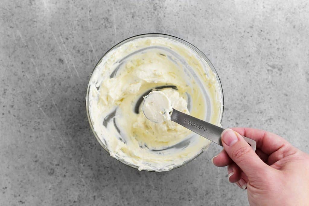 cream cheese filling in a measuring spoon