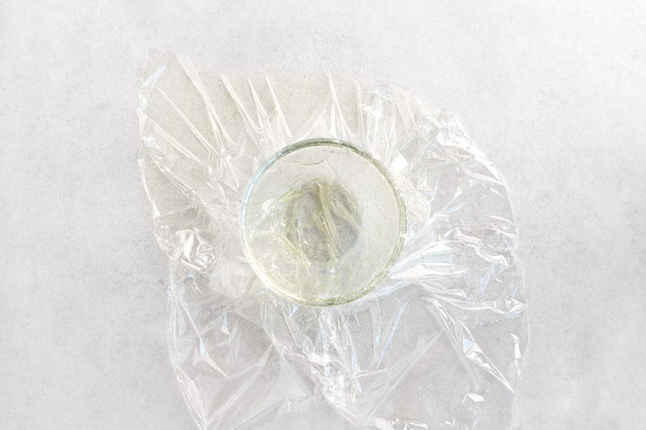 plastic cooking film coated in cooking spray in a bowl