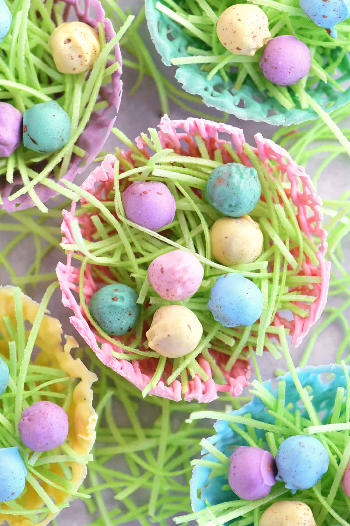 bright chocolate easter nests with edible grass and pretzel nuggets inside