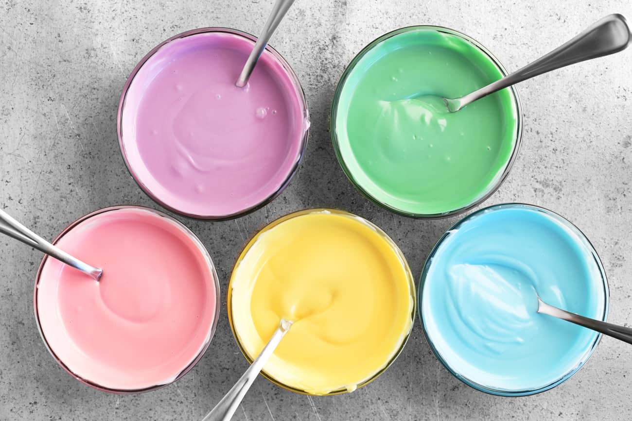 purple, green, pink, yellow, and blue bowls of candy melts