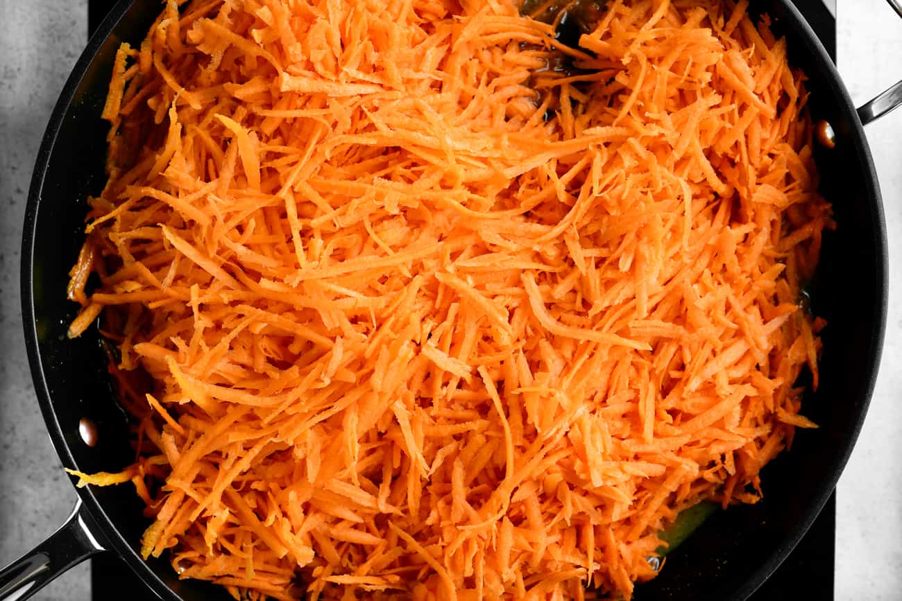 shredded carrots in a frying pan