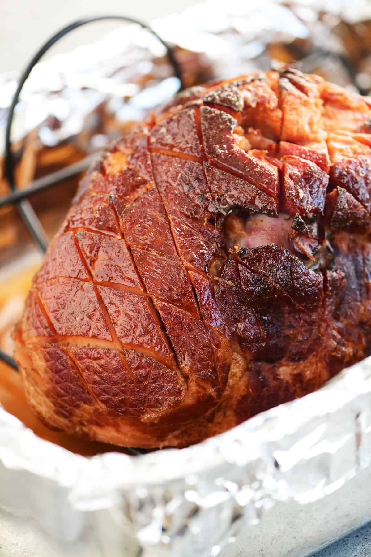 cooked glazed ham in a roasting pan