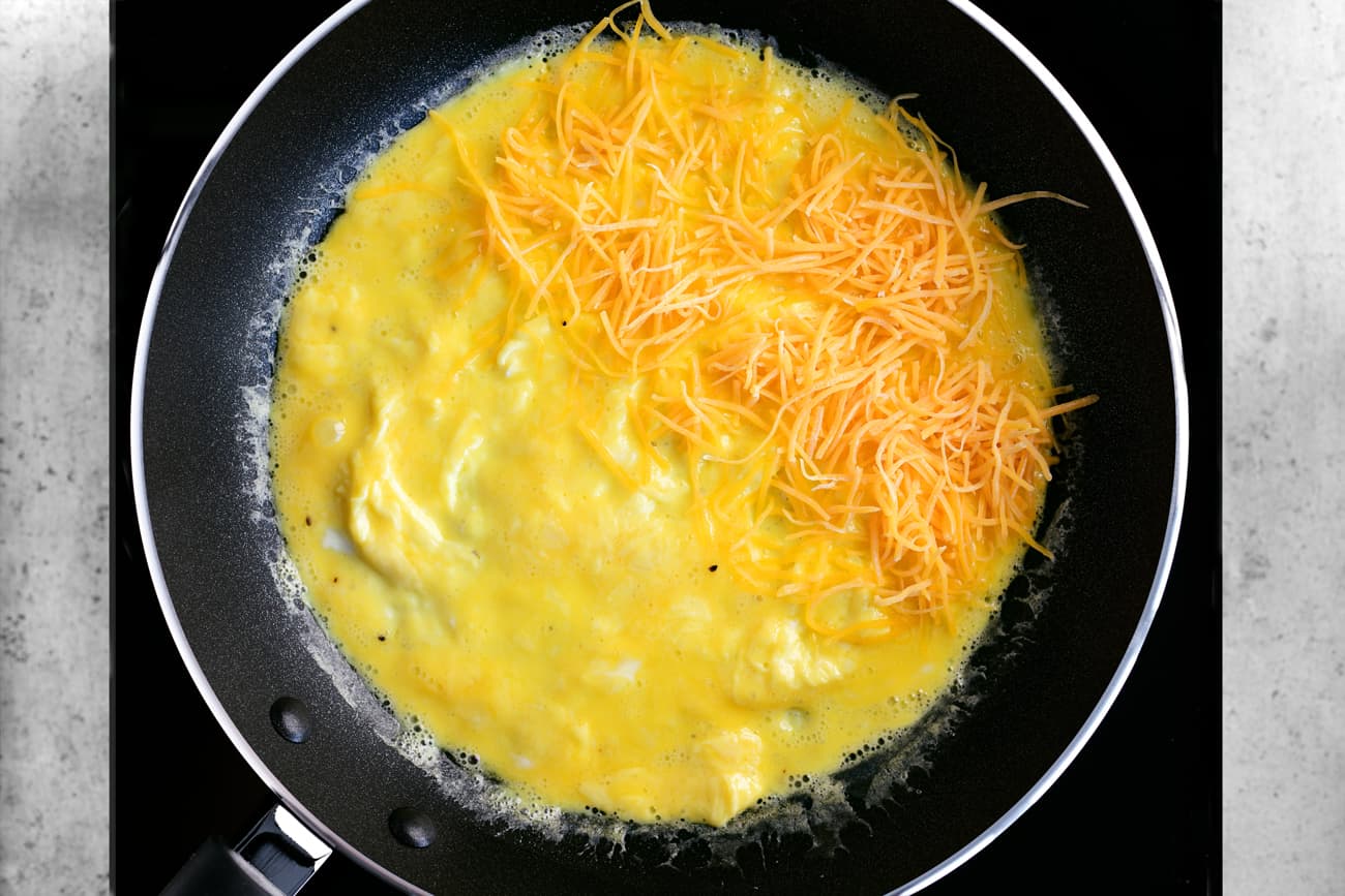 shredded cheese added to half of the omelet
