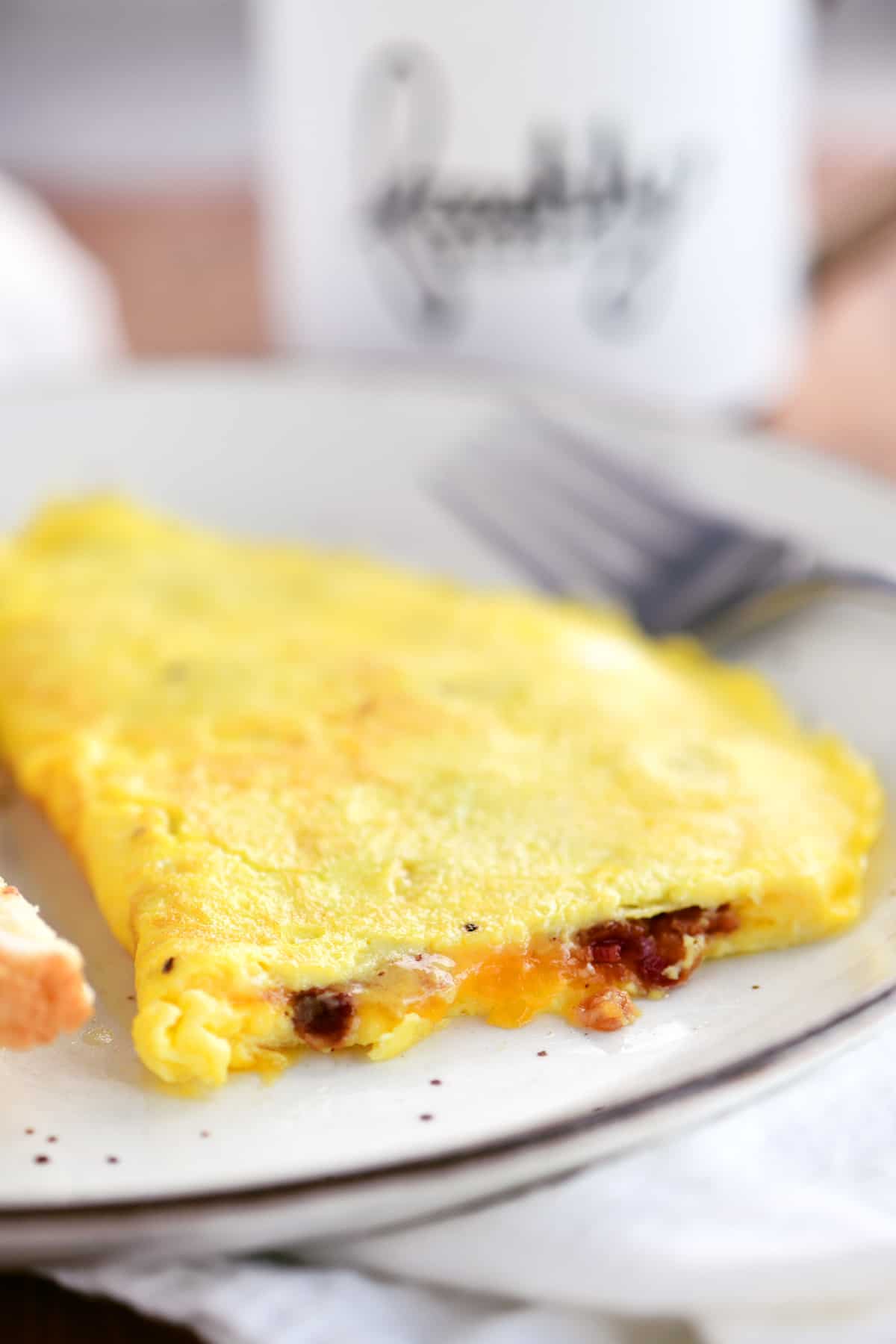 view of the melted cheese and crispy bacon inside the omelet
