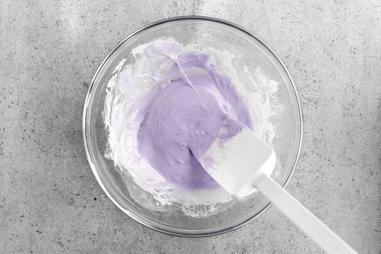 adding lavendar food coloring to the marshmallow mixture