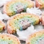 rainbow rice krispie treats and white fluffy cotton candy on a pan