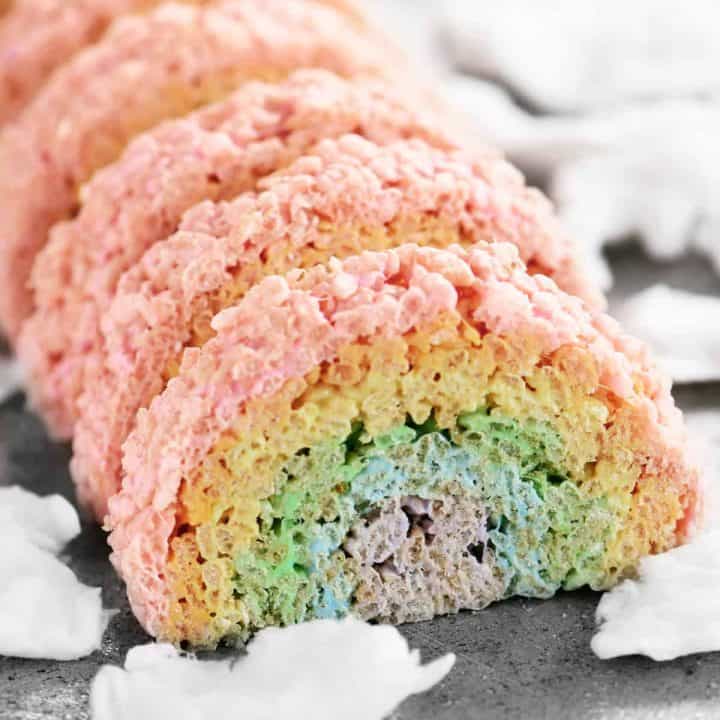 individual rainbow treats lined up on a pan