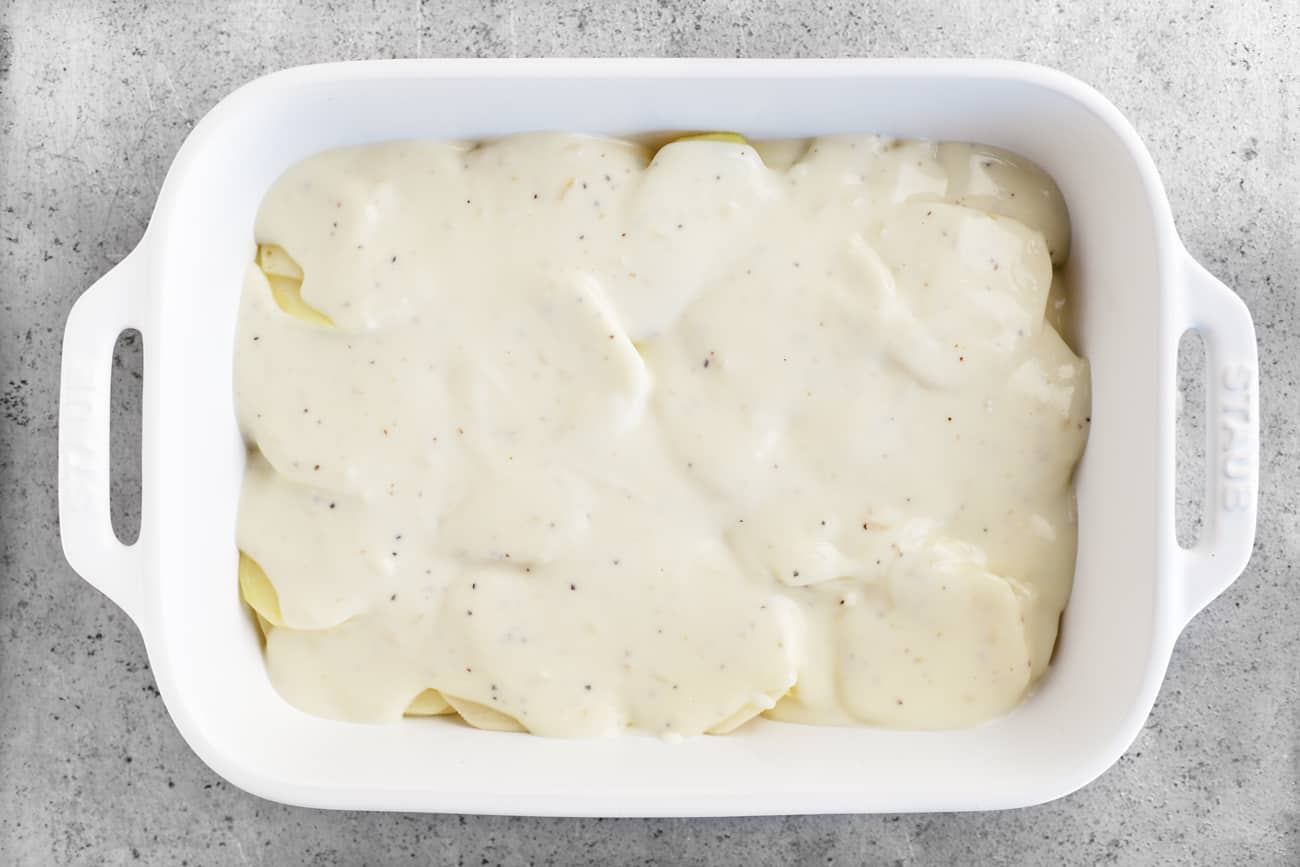 sauce over potatoes in a baking dish