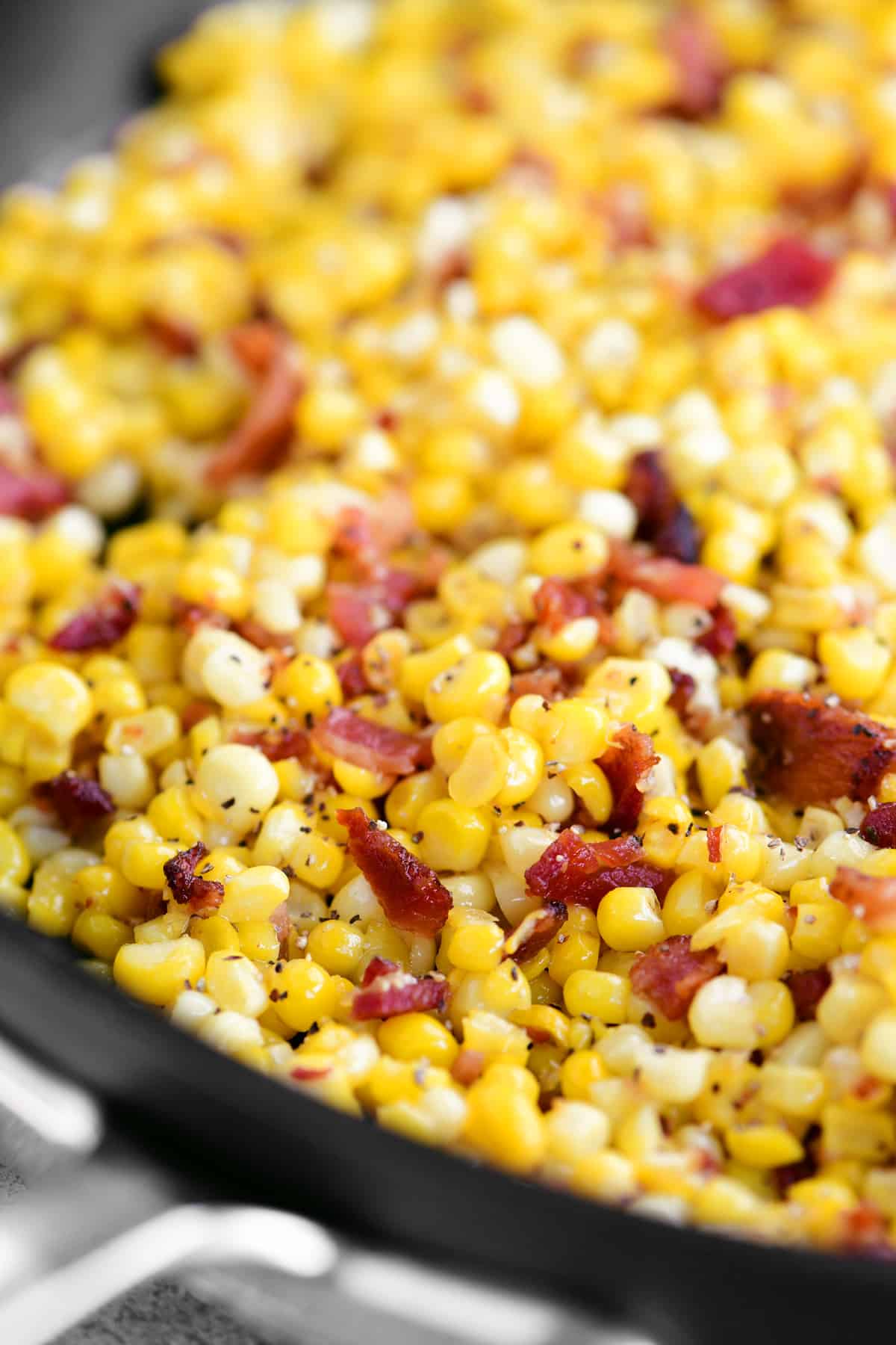 a close-up photo of the bacon and corn in the pan