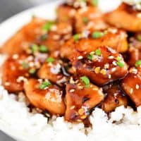 sesame chicken in a bowl with white rice
