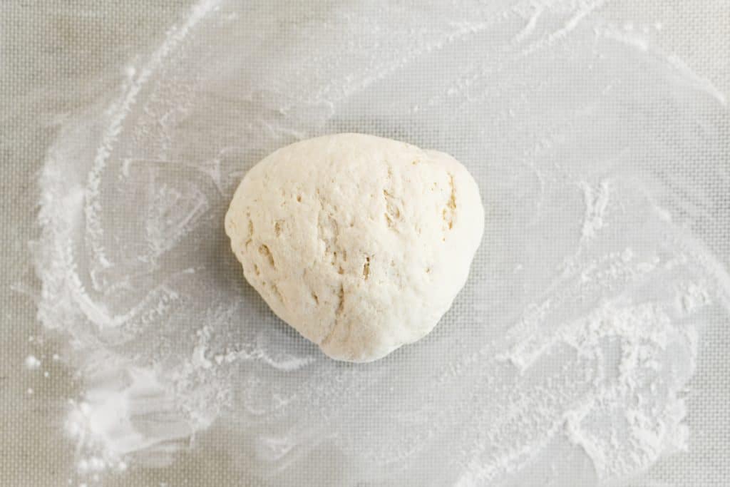 a ball of dough on a floured surface