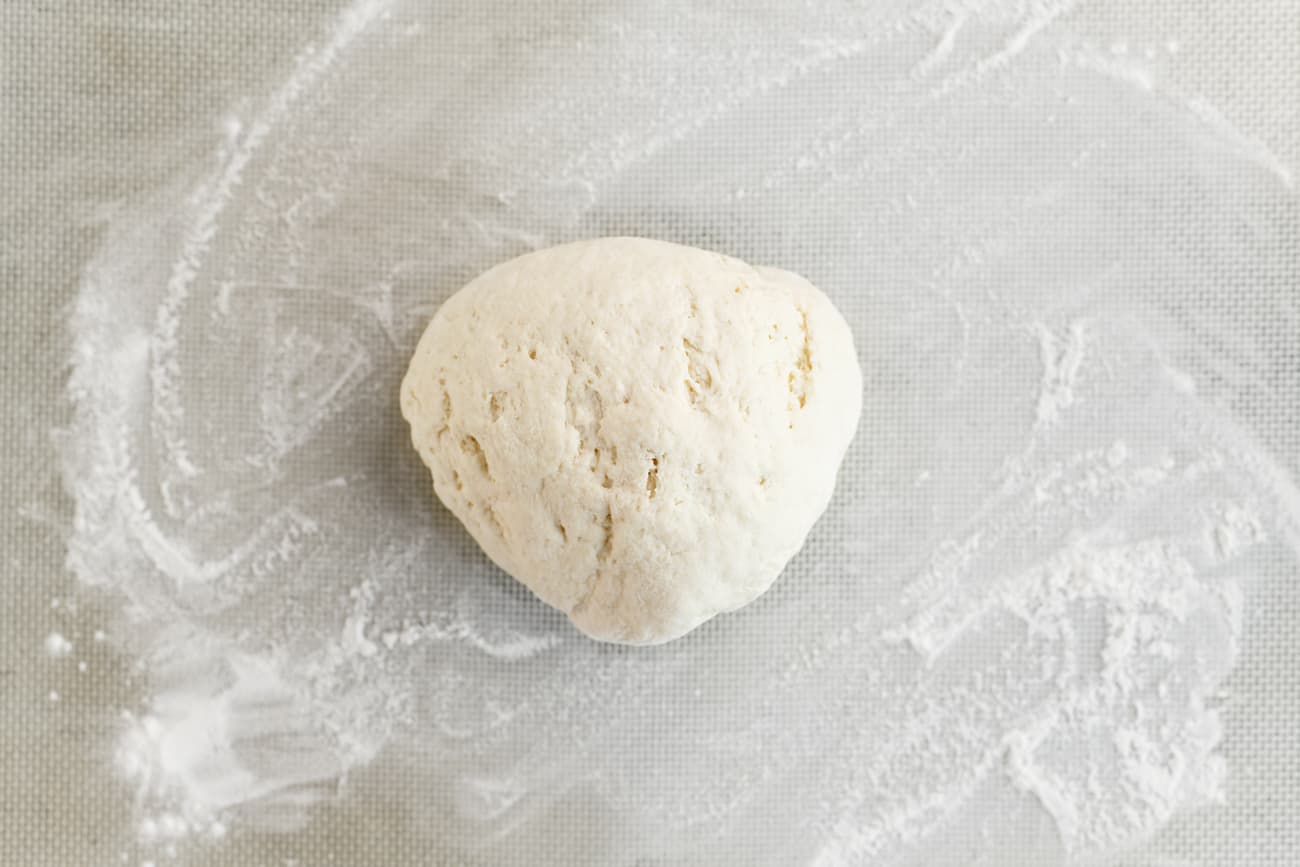 a ball of dough on a floured surface