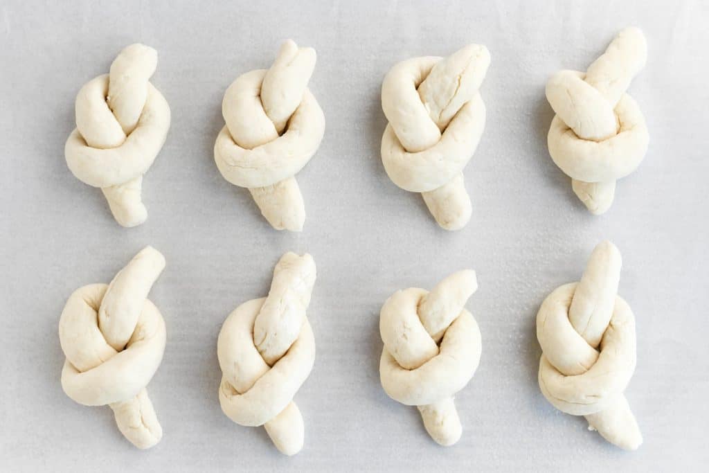 unbaked garlic knots on a baking sheet