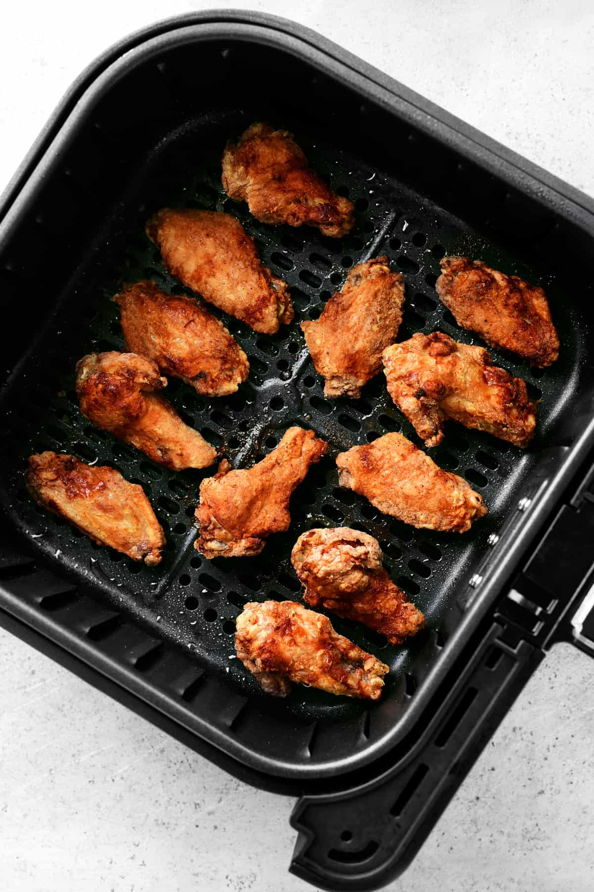 fried chicken wings in the air fryer basket