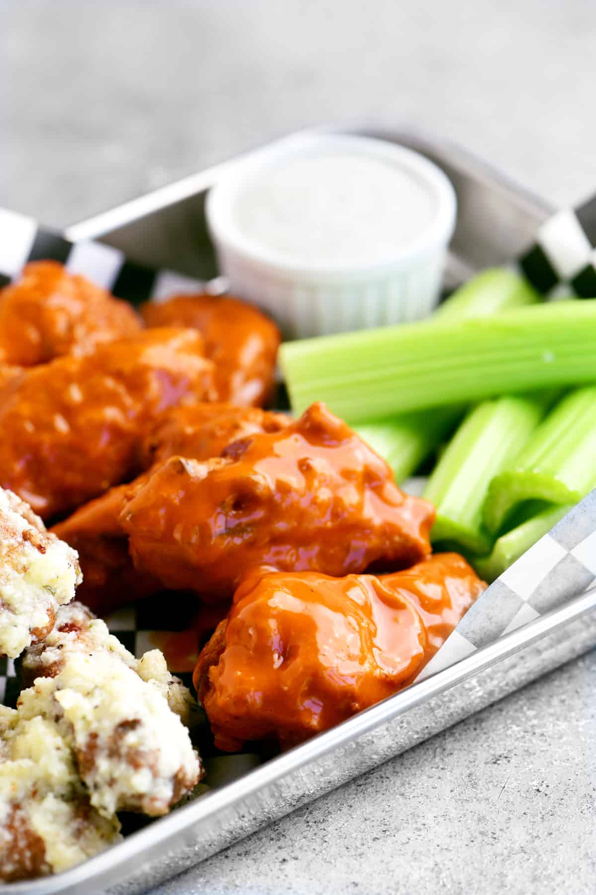 chicken wings with buffalo sauce and celery on a tray