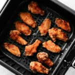 air fryer chicken wings in basket.
