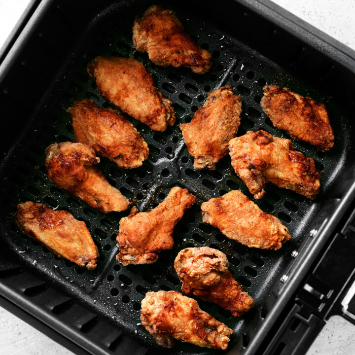 air fryer chicken wings in basket.