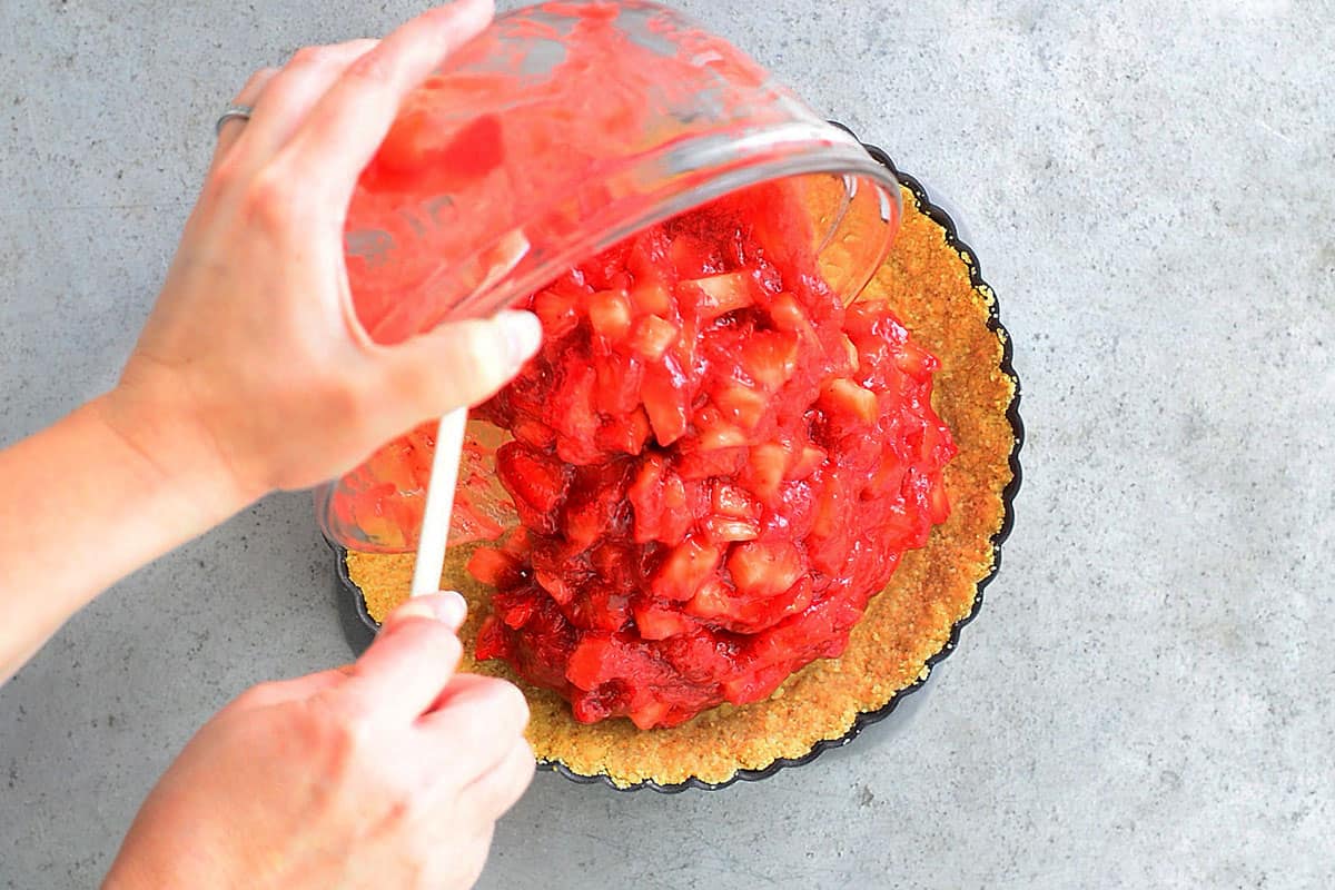 pour strawberries into pie crust
