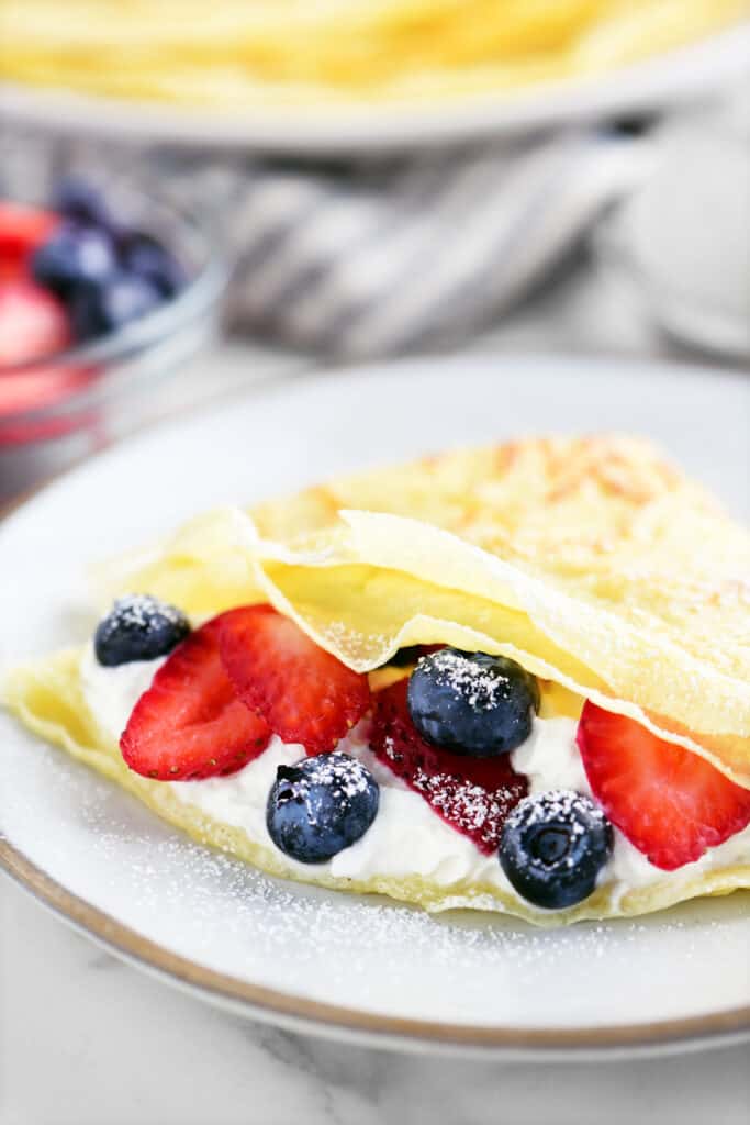 berries and cream inside a folded crepe