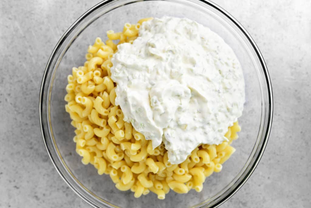 macaroni salad topping and pasta noodles in a glass bowl