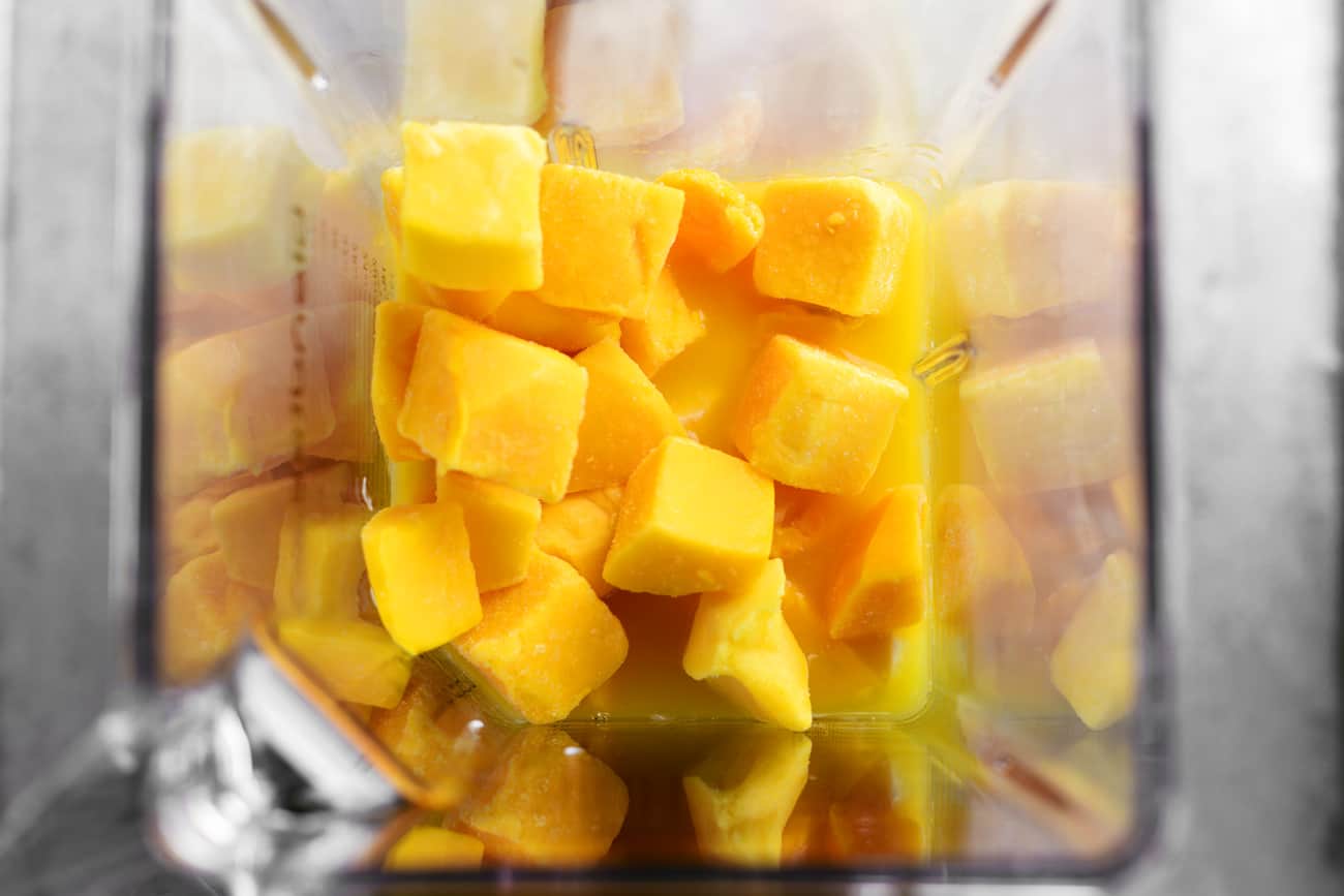 cubed mango pieces in a blender cup