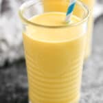 mango smoothies with white and blue striped straws