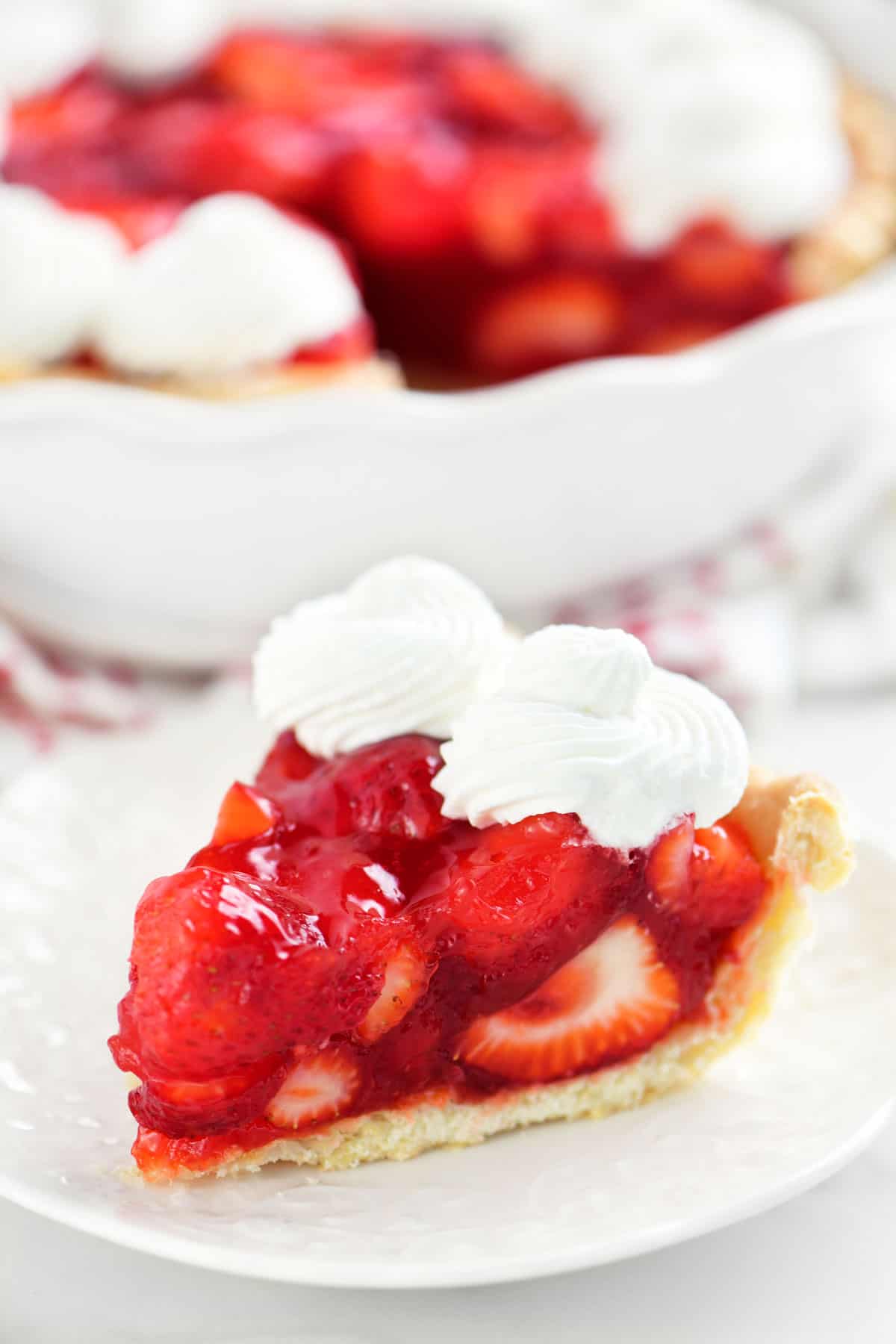 a slice of strawberry pie on a small white plate