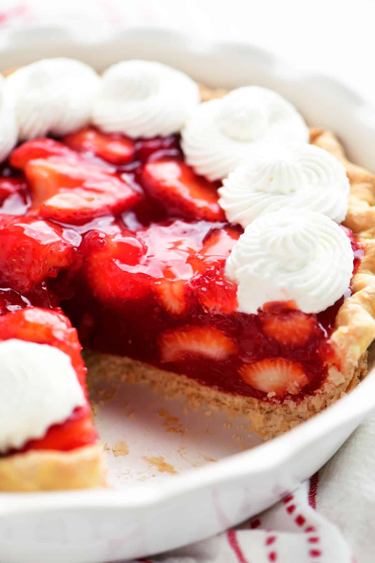 a strawberry pie with a piece cut out