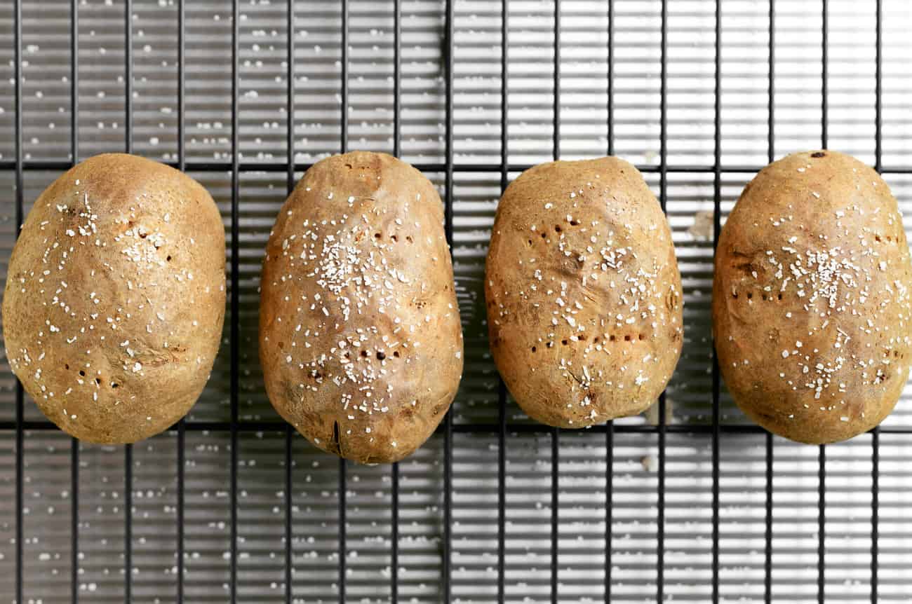 four spuds on a wire rack