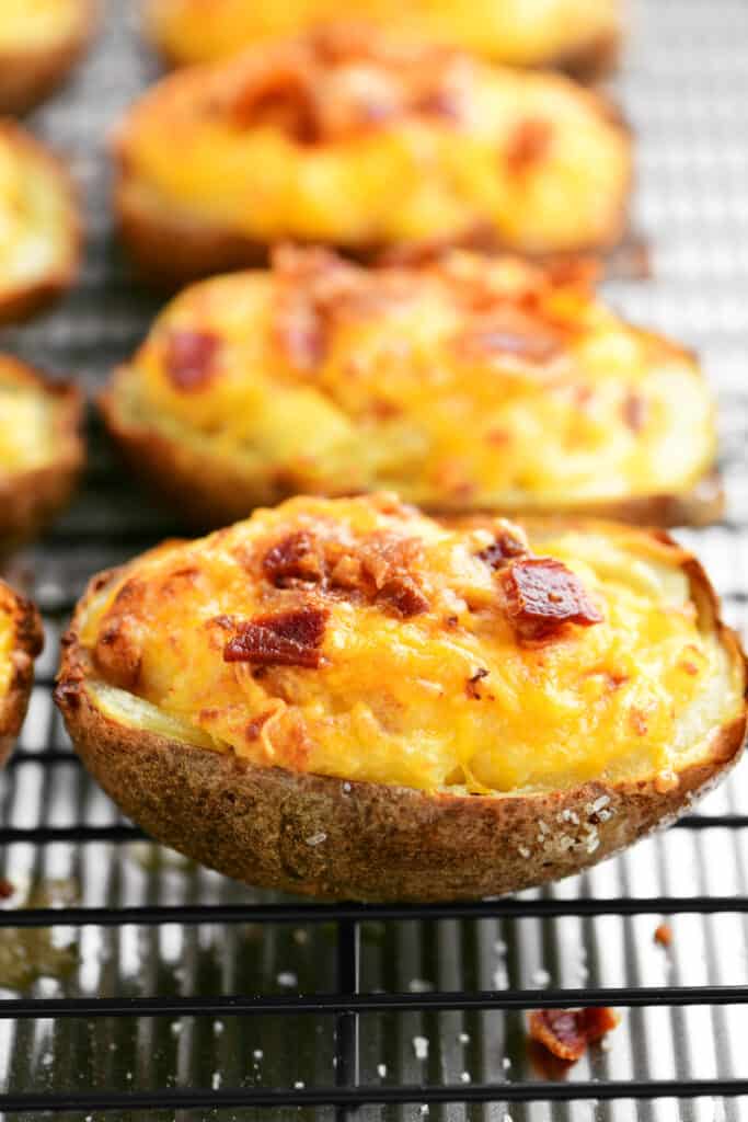 twice baked potatoes with bacon and cheese cooling on a wire rack