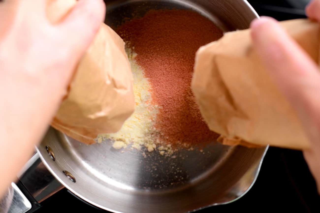 dumping jello and pudding into a saucepan