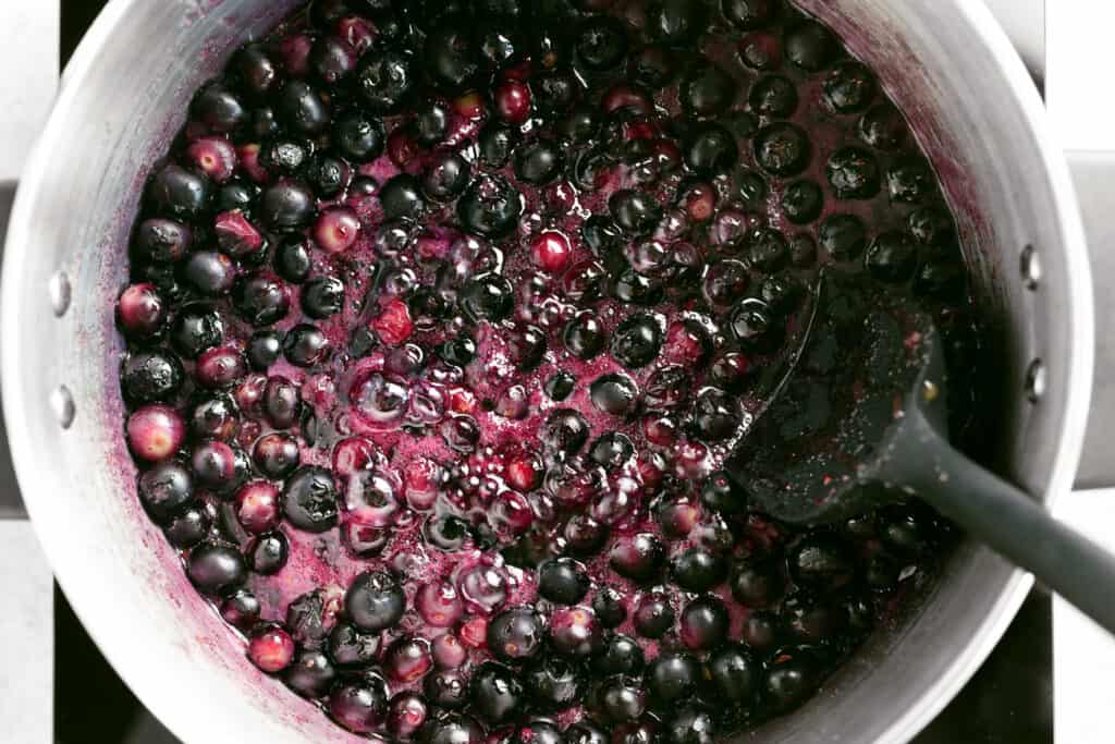a spatula and blueberry pie filling in a pot