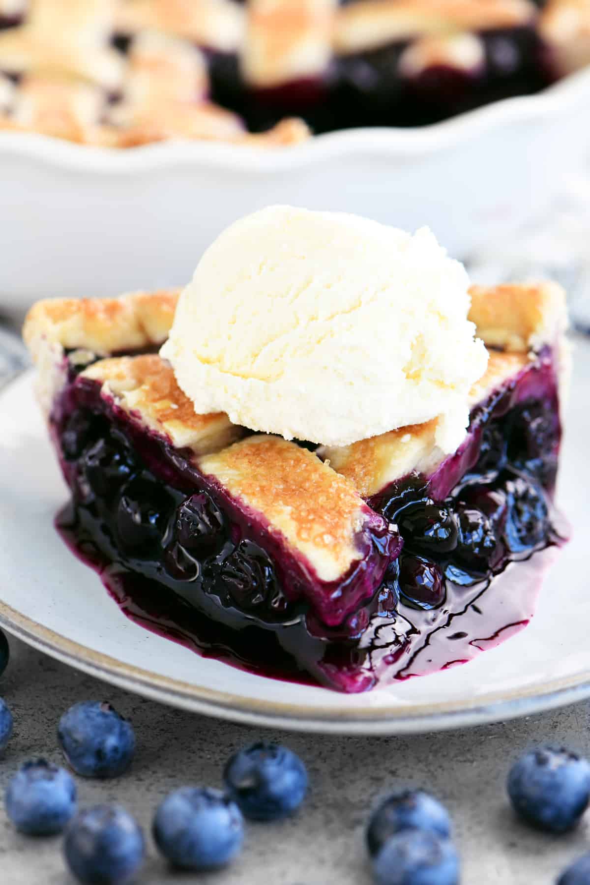 slice of blueberry pie with vanilla ice cream on top
