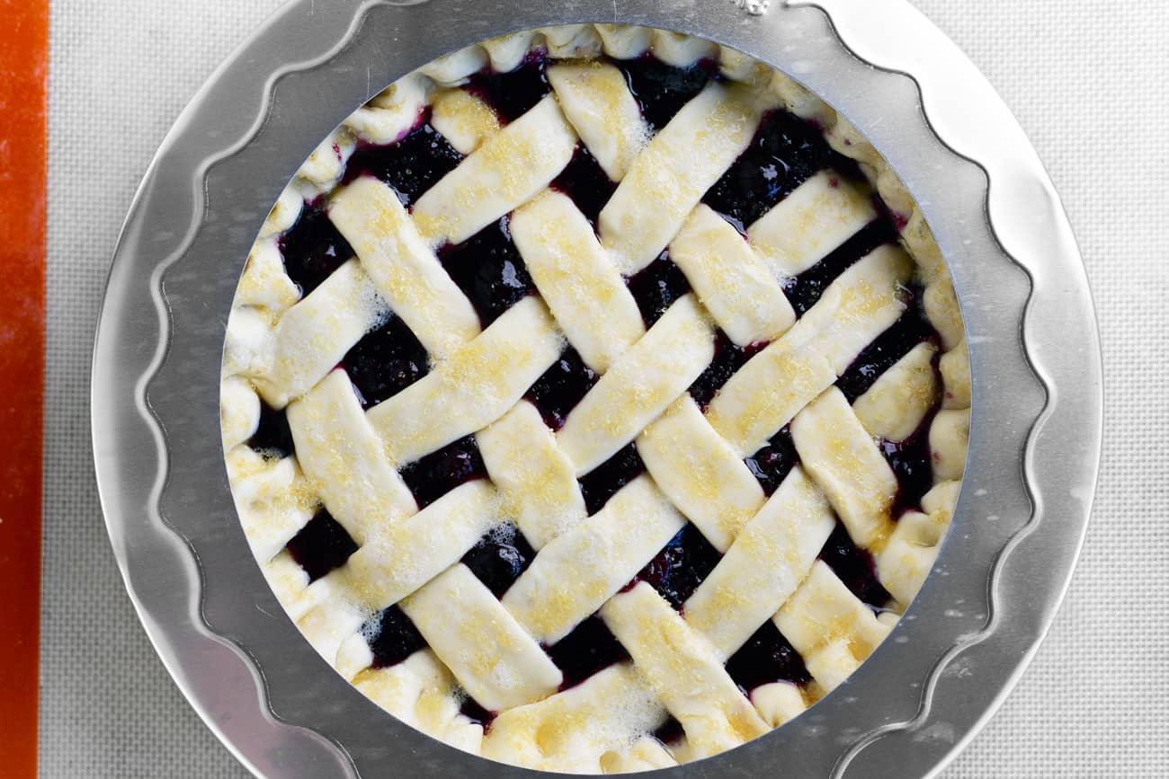 a pie shield on top of the blueberry pie