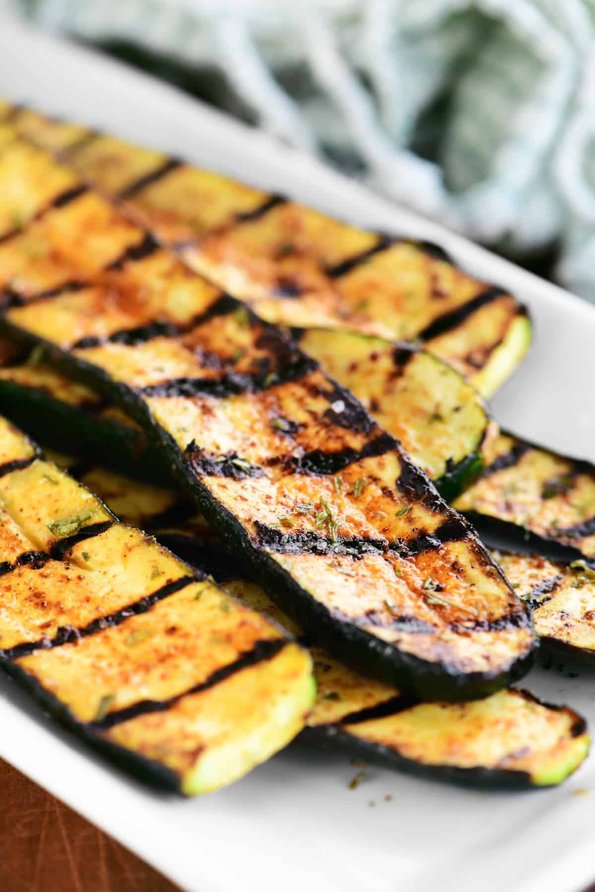 a small stack of grilled zucchini on a platter