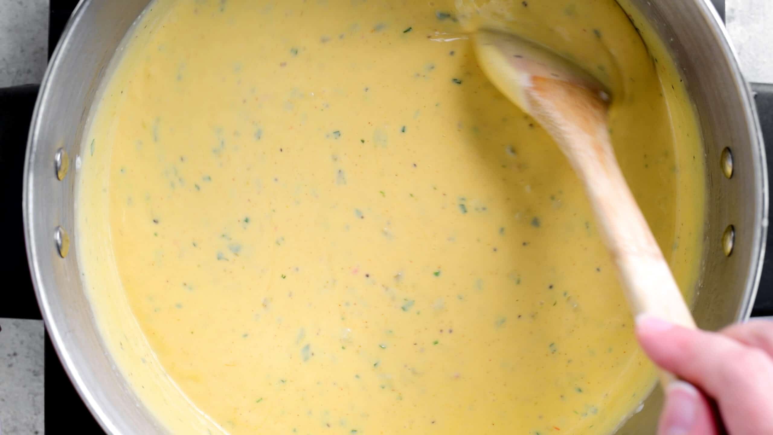 stirring cheese sauce