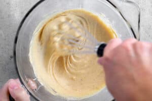 whisking batter in a bowl